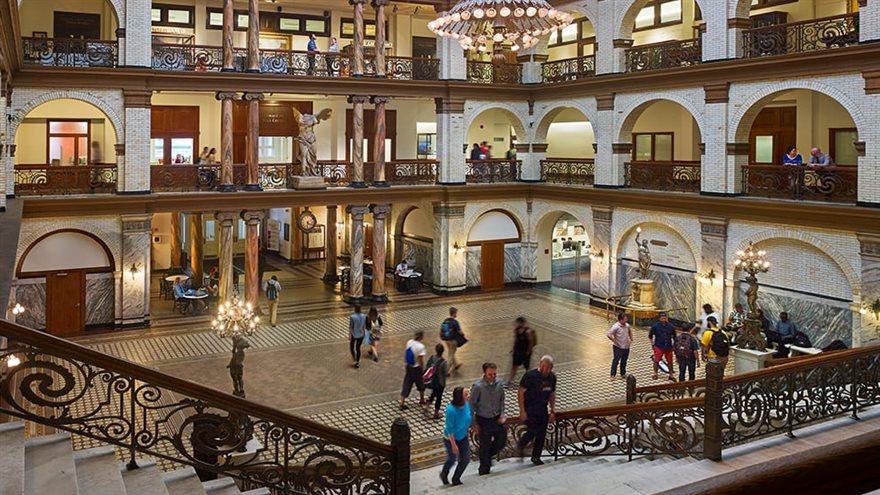 A view of people walking around taken from the staircase in the Great Court of Drexel University&#39;s Main Building.