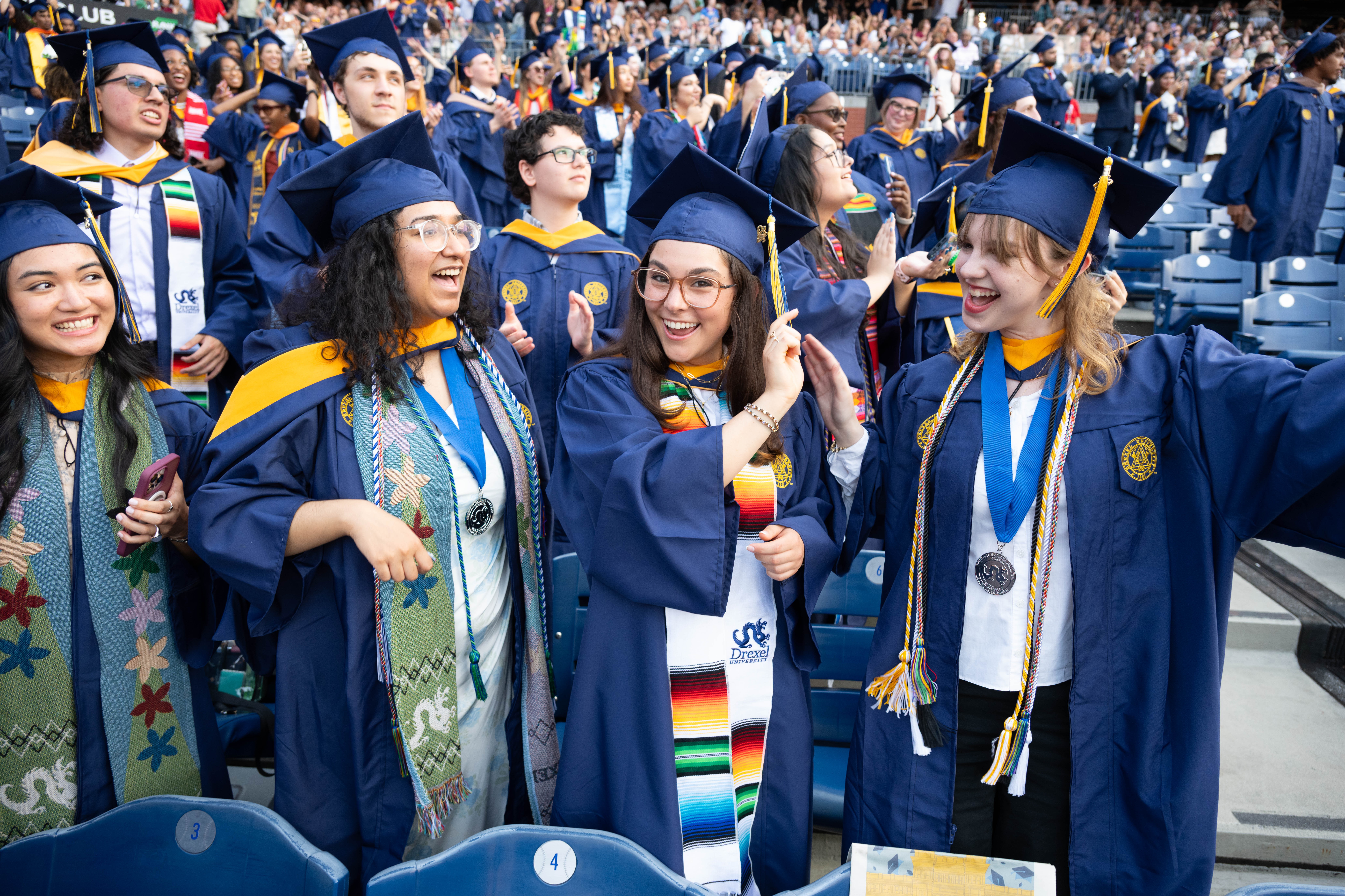 A student turning a tassel on a graduation cap.