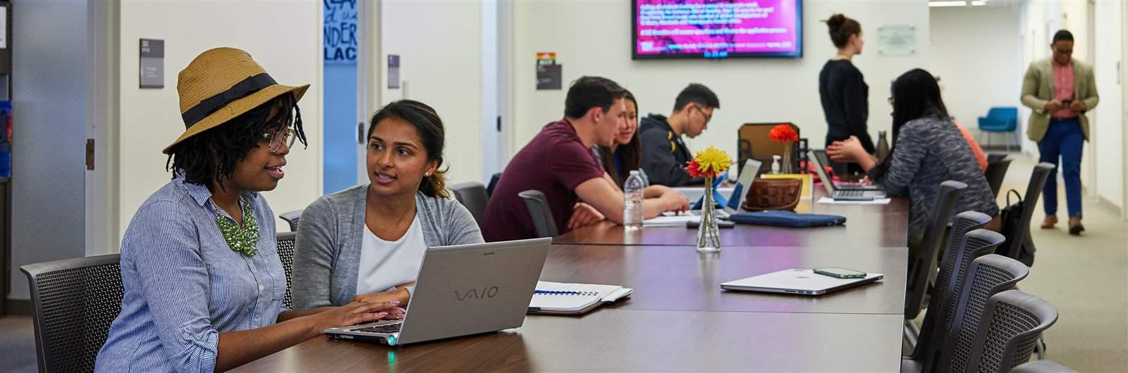 students listening to professor lecture in-person
